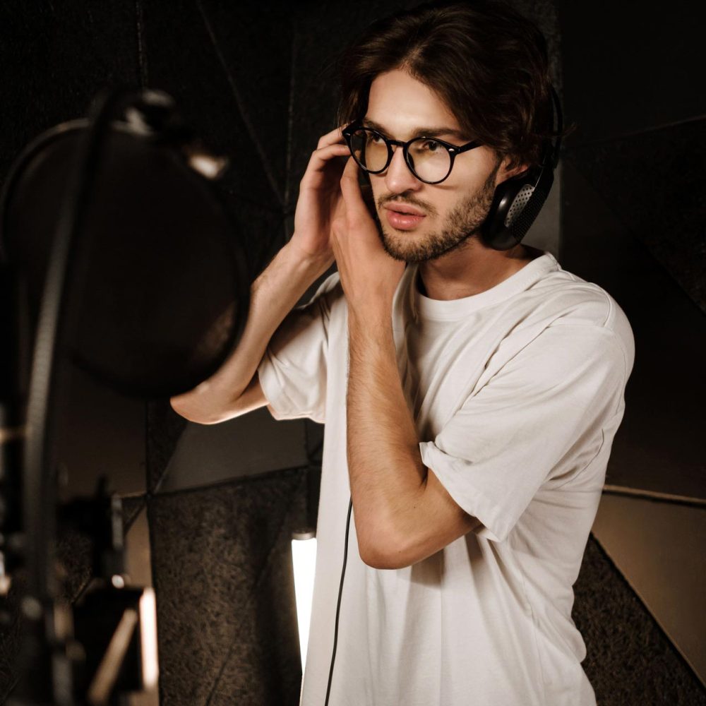 young-male-singer-wearing-headphones-preparing-rec-GA3Y8N4.jpg